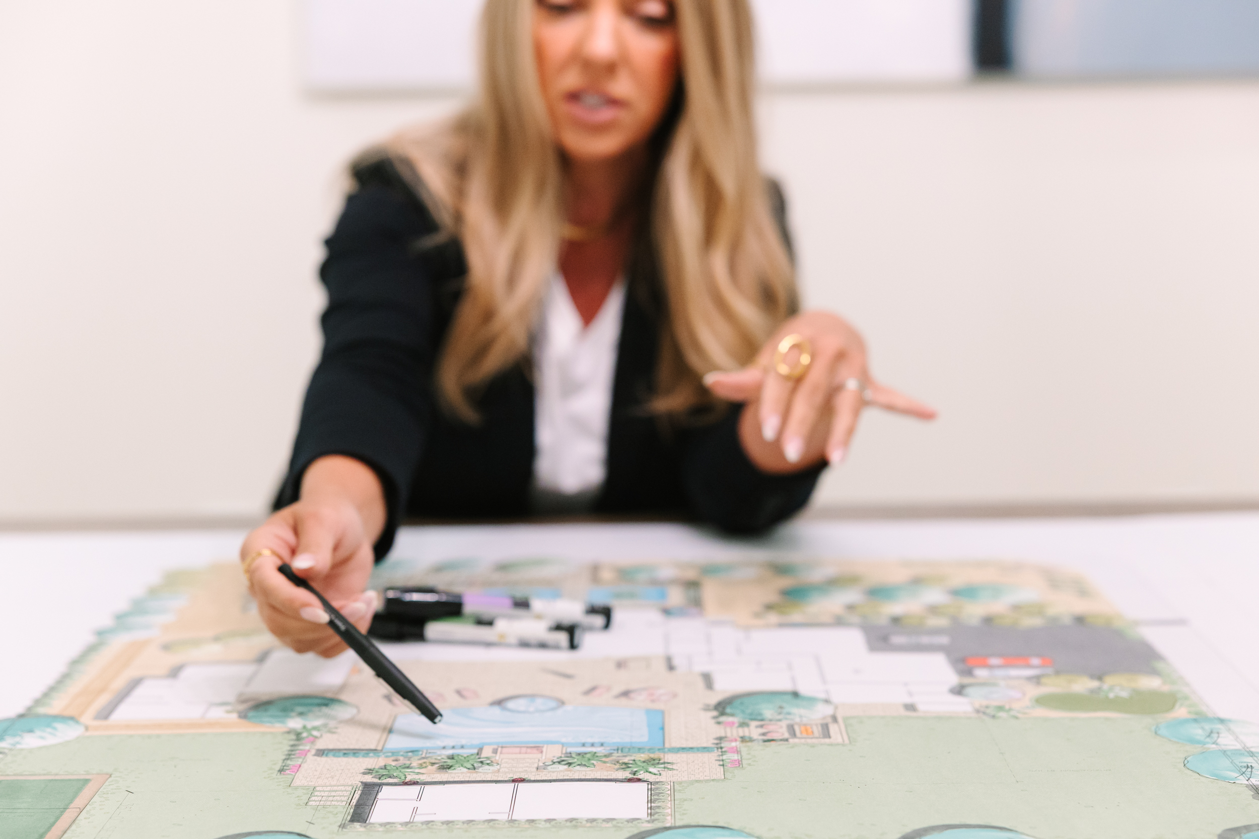 Designer Pointing at Landscape Design Plans